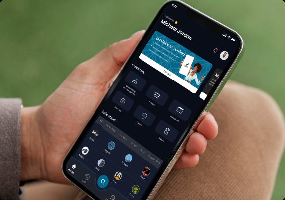 Safex app held in hand showing the verification prompt and quick link icons